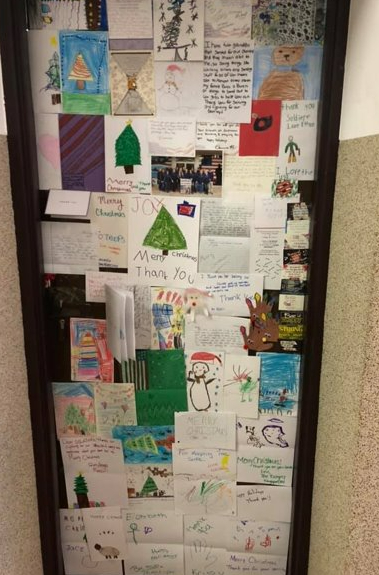 Holiday cards and drawings from Supplies for Soldiers on service member's door. 
