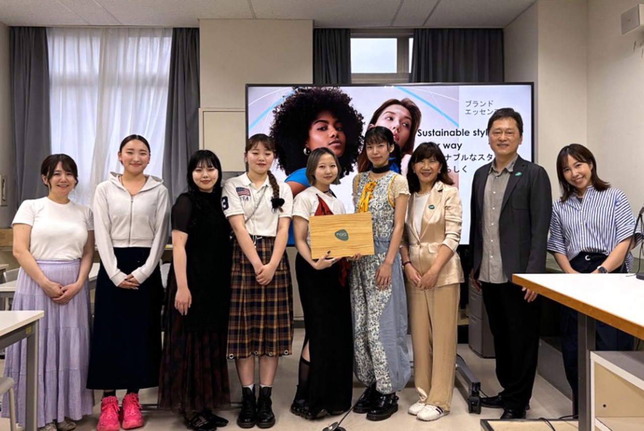 Nine people pose at Bunka Fashion College during the Naia team’s presentation