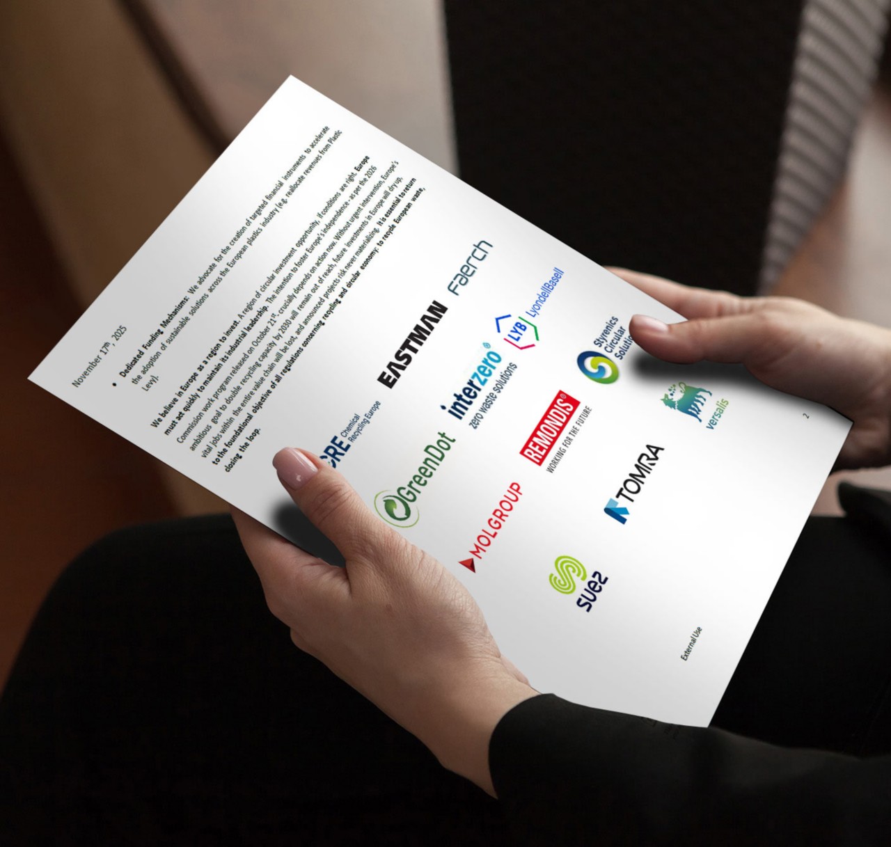 Person holding a printed proposal featuring multiple company logos. 