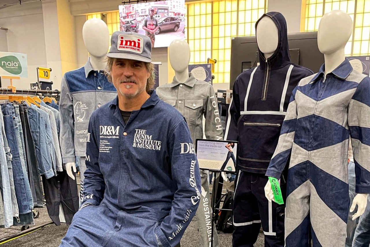 Loren Cronk wears a denim jumpsuit with The Denim Institue and Museum logo on it. 