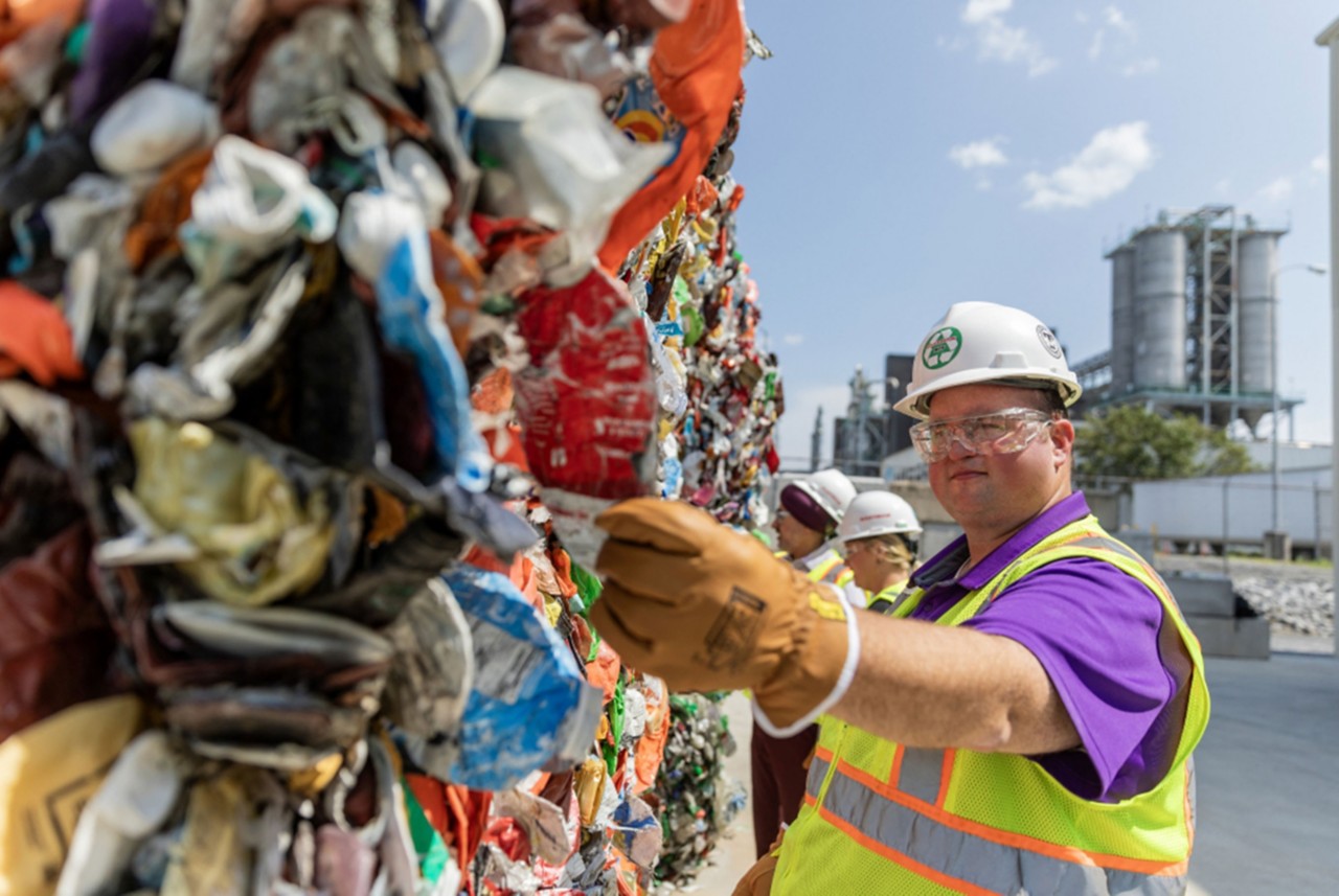 Spencer Tidwell holding up crushed plastic feedstock for Eastman’s methanolysis plant. Spencer Tidwell holding up crushed plastic feedstock for Eastman’s methanolysis plant.