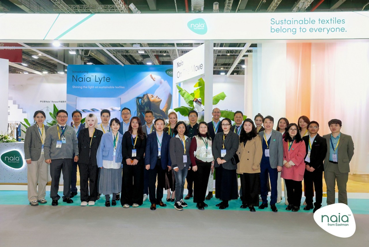 The Naia team poses in front of the booth. 