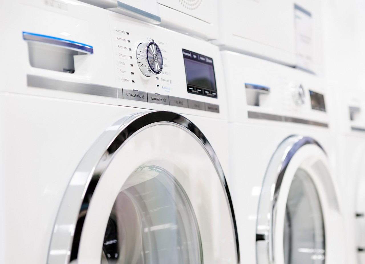 Two white, front-loading washing machines.