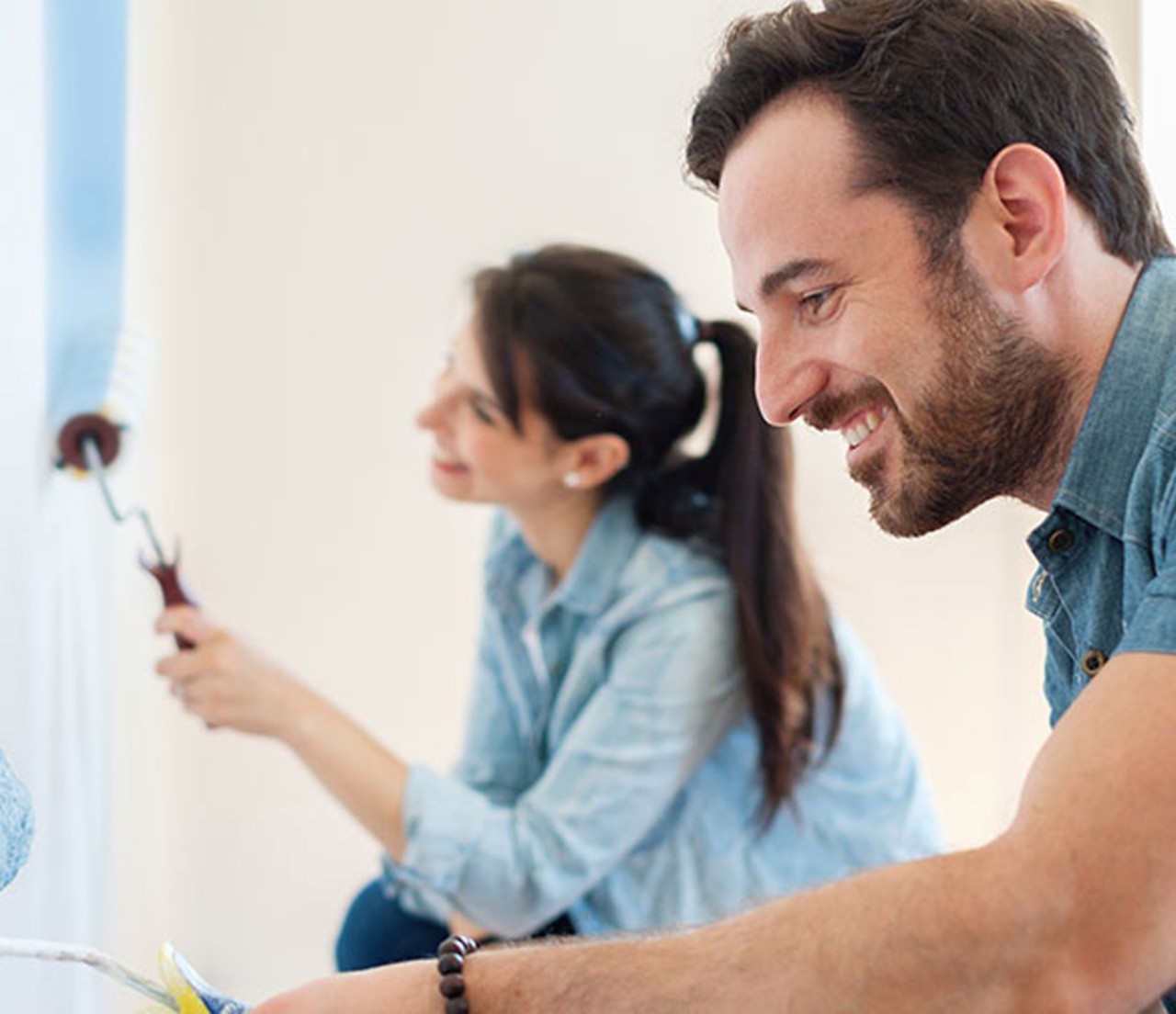 Couple painting wall blue